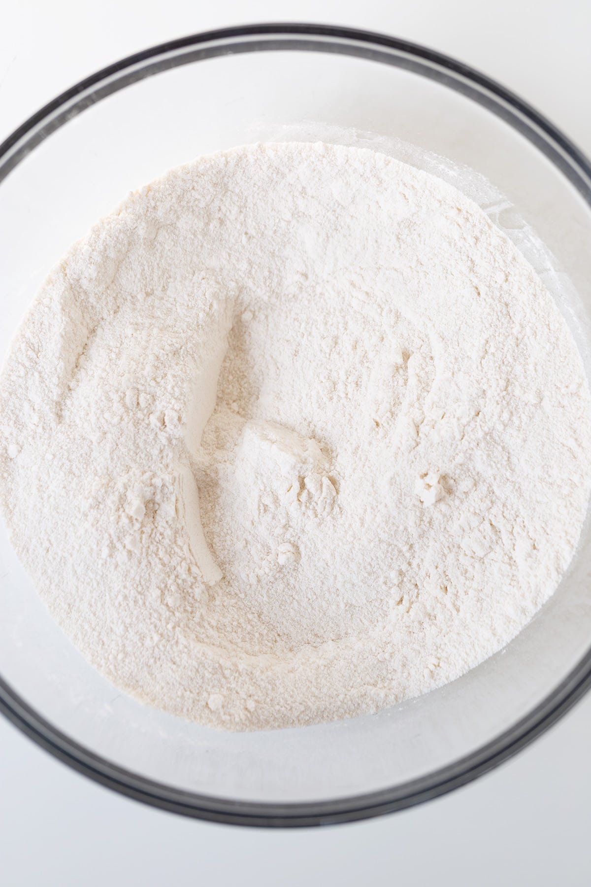 dry ingredients in a bowl on a white surface.
