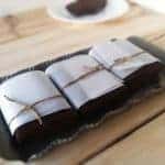 Three squares of fudge brownies on a tray.