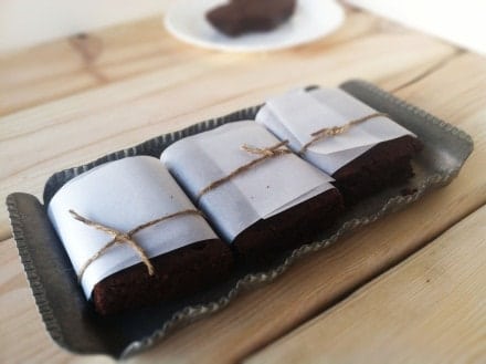 Three squares of fudge brownies on a tray.