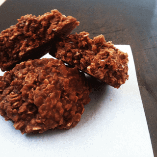 A stack of no-bake chocolate cookies on a paper.