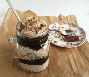 A Twix trifle served in a mason jar.