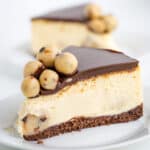 slice of salted caramel cookie dough cheesecake on a white plate