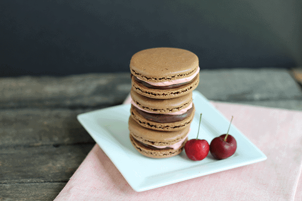 chocolate macaron recipe: chocolate macarons filled with cherry frosting and chocolate ganache