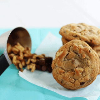 Chewy chocolate chip cookies with walnuts on a napkin.