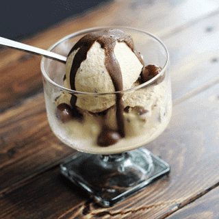 Chocolate covered coffee bean ice cream in a glass.
