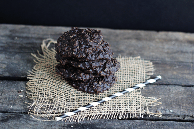 stack of no bake dark chocolate cookies on a weathered wooden table top