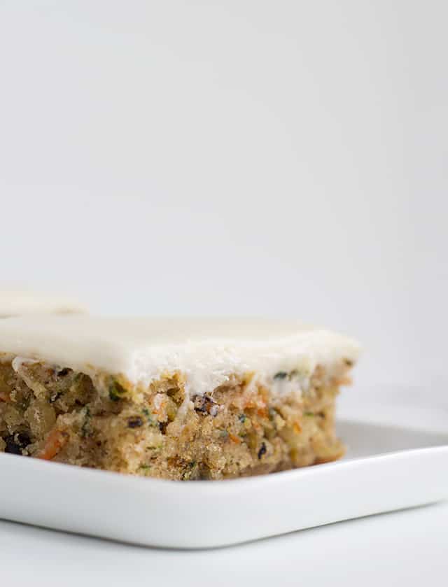 side view of a slice of zucchini bars with cream cheese frosting