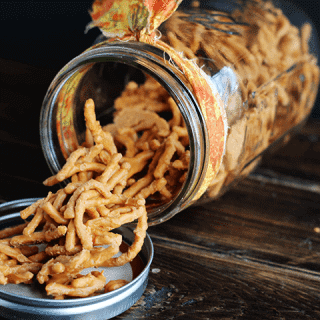 A jar of Chow Mein Candy sitting on top of a wooden table.