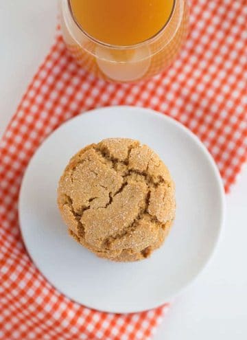 overhead photo of one apple cider snap cookie on white plate