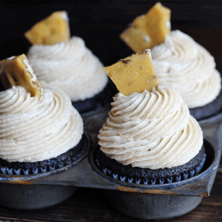 Three chocolate cupcakes topped with maple pecan buttercream frosting.