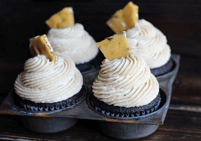 Three chocolate cupcakes topped with maple pecan buttercream frosting.