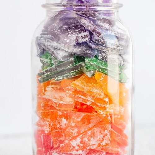 mason jar full of colorful hard rock candy on a white surface