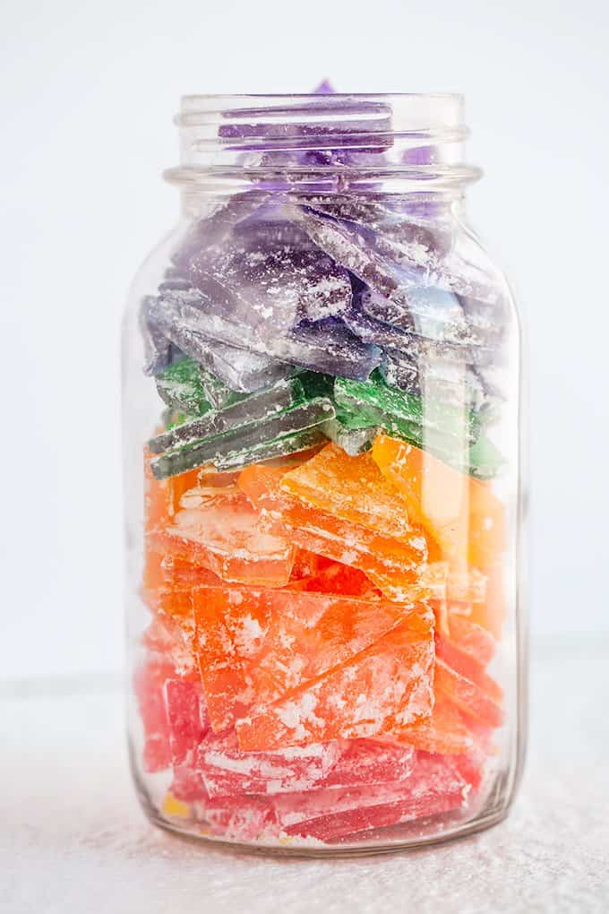 mason jar full of colorful hard rock candy on a white surface