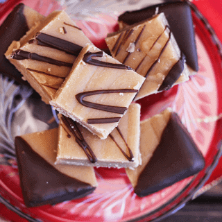 A platter of peanut butter fudge on a crimson dish.