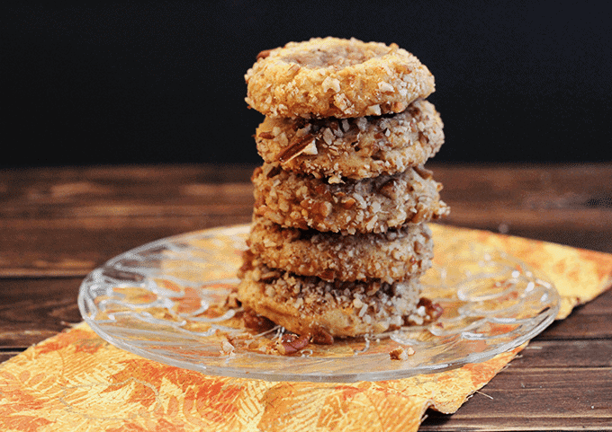 A stack of Pecan Sweet Potato Thumbprint cookies on a plate.