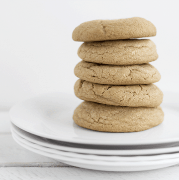 Maple brown sugar cookies stacked on a white plate.