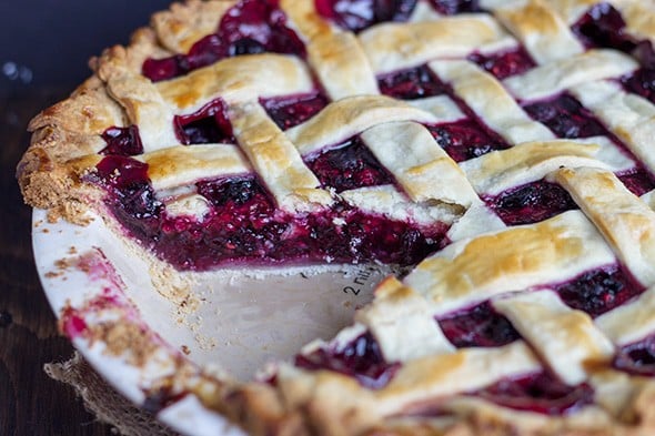 close up image of a Mixed Berry Pie with a slice removed