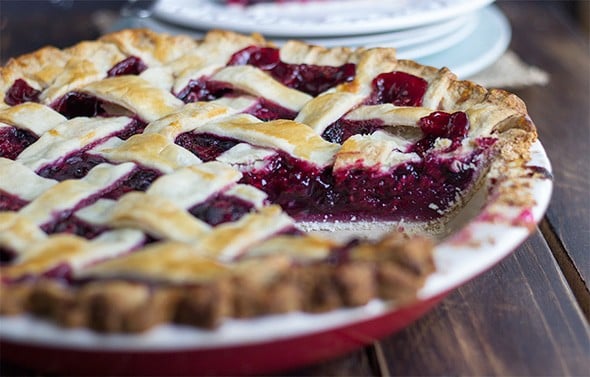 close up image of a lattice crust fruit pie made with blueberries, blackberries, and raspberries