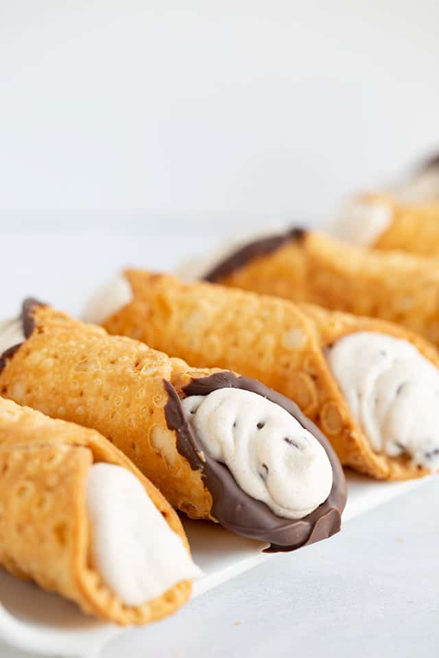 cannlis on a white platter on a white surface