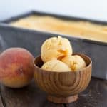 wooden ice cream bowl holding 3 scoops of Peach Sorbet