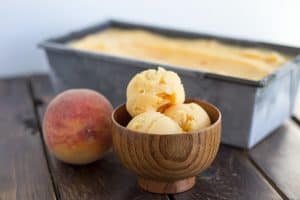 wooden ice cream bowl holding 3 scoops of Peach Sorbet