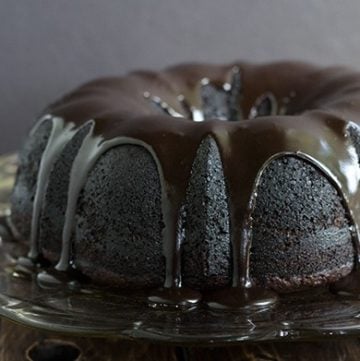 A Triple Chocolate Zucchini Bundt Cake on a glass plate.