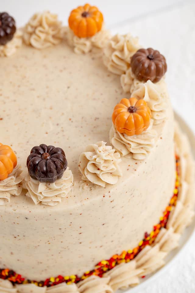 close up of pumpkin truffles on top of a pumpkin spice cake