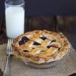 A pie with Concord Grape Pie Filling on a plate.