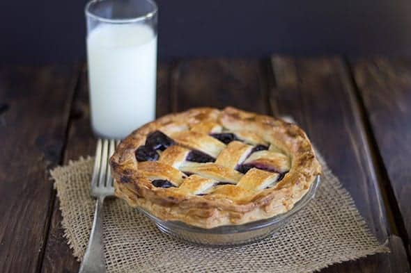 A pie with Concord Grape Pie Filling on a plate.