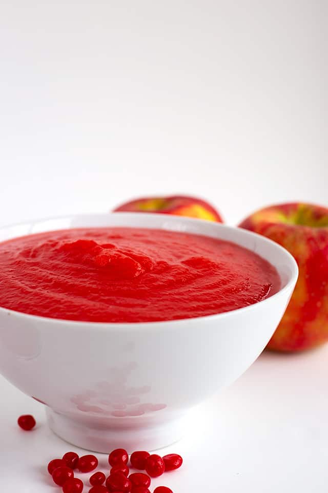 Side shot of red hot applesauce in a large white bowl