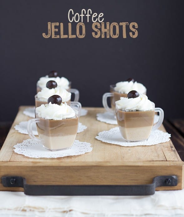 Coffee jello shots served on a rustic wooden tray.