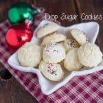 Drop sugar cookies on a plate with Christmas ornaments.