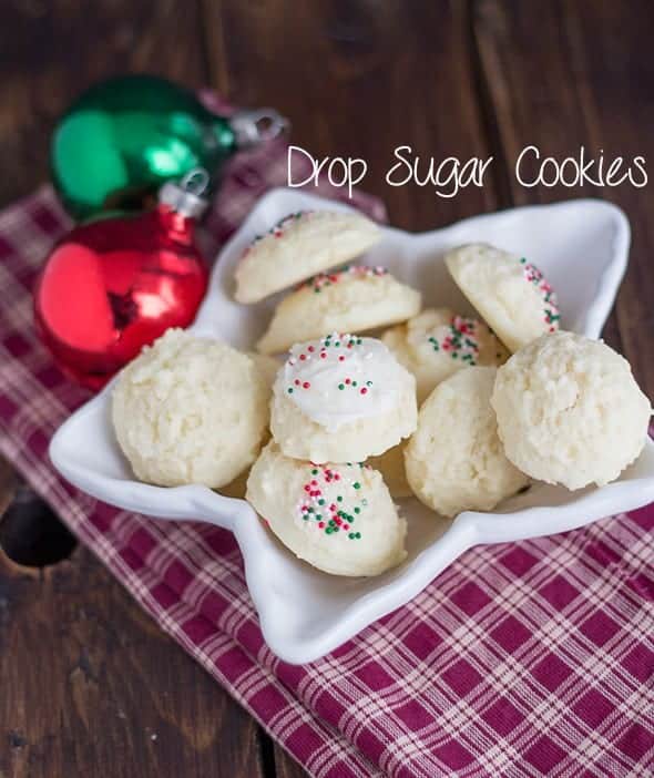Drop sugar cookies on a plate with Christmas ornaments.