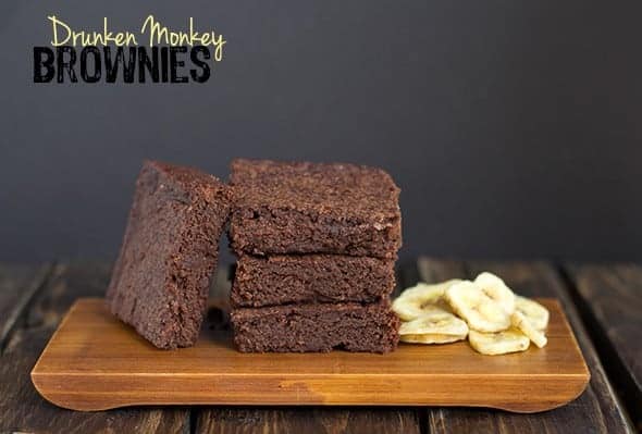 Drunken Monkey Brownies displayed on a rustic wooden cutting board.