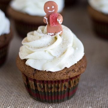 gingerbread cupcakes with white chocolate frosting and a gingerbread topper