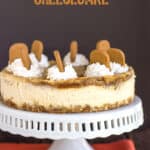 cheesecake on a cake plate with orange fabric under it