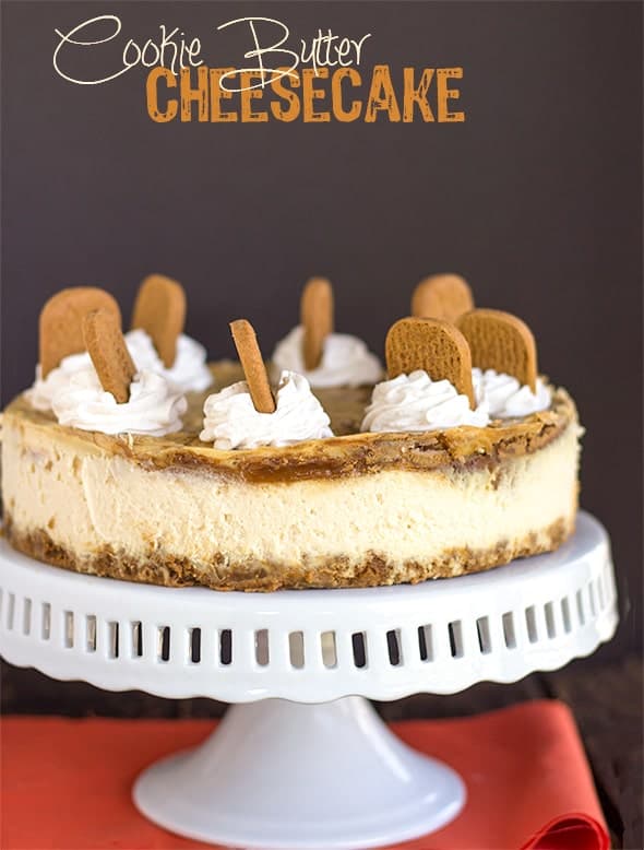 cheesecake on a cake plate with orange fabric under it
