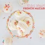 French macarons with Fruity Pebbles sprinkles in a glass bowl.
