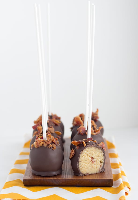 Maple Bacon Cake Pops with one cut open, revealing the center