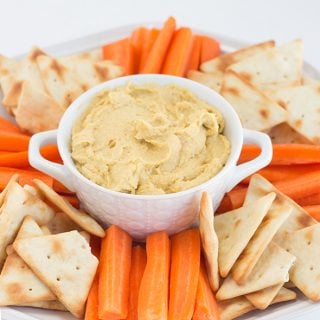 Vegetable hummus with carrots and crackers.