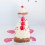 Cherry cupcakes with white chocolate frosting.
