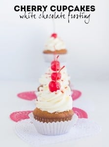 Cherry cupcakes with white chocolate frosting.
