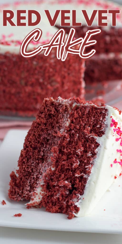 A slice of red velvet cake with white chocolate frosting on a white plate.