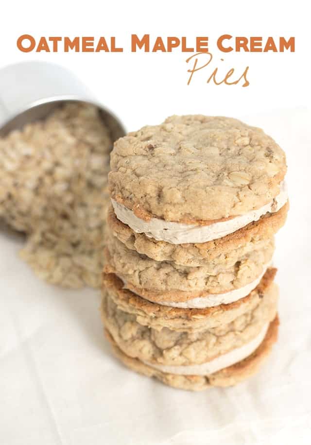 stack of sandwich cookies with a measuring cup full of oats behind it