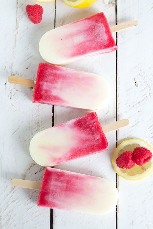 Four raspberry lemonade popsicles.