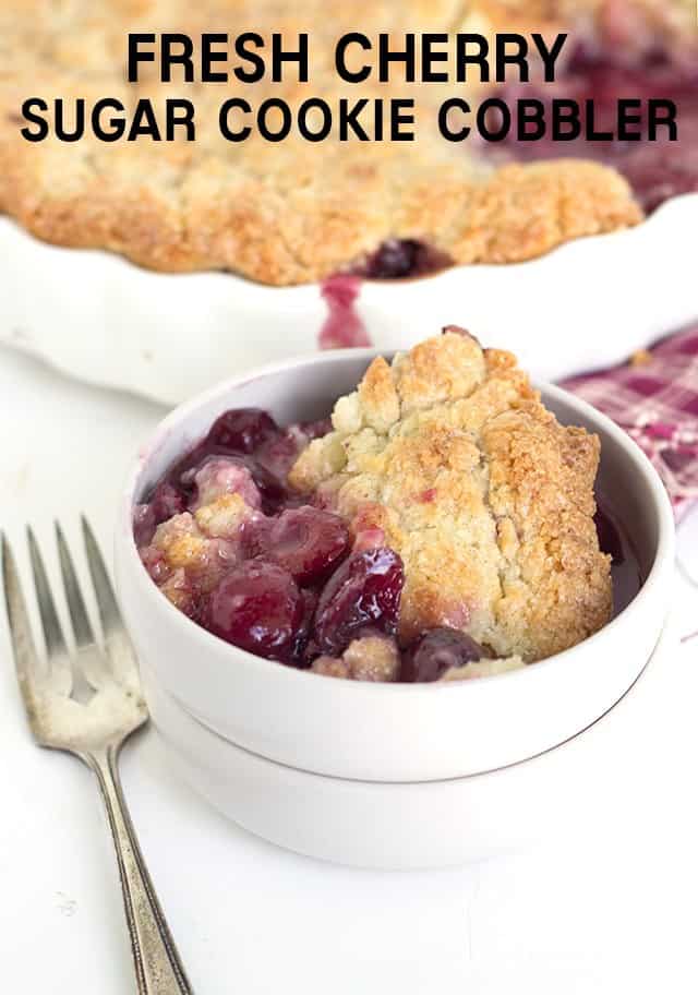 titled image - fresh cherry cobbler with a sugar cookie crust served in a white bowl