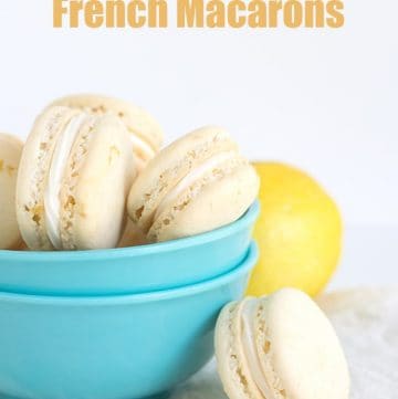 Lemon meringue macarons in a blue bowl.