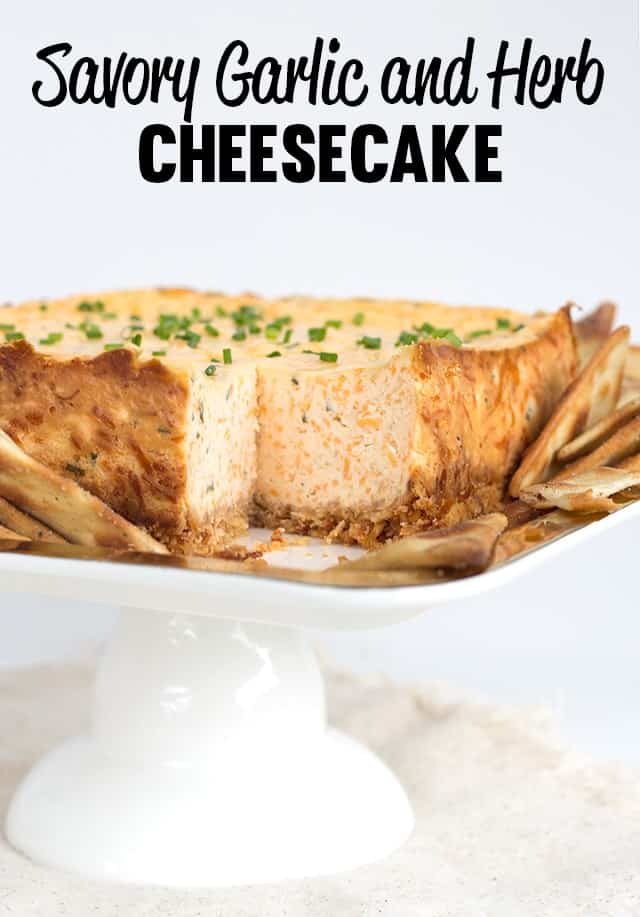 Savory square cheesecake on a square cake plate with pita chips