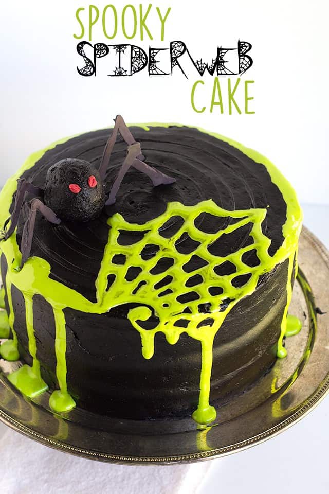 A cake with a spooky spiderweb design on a plate.