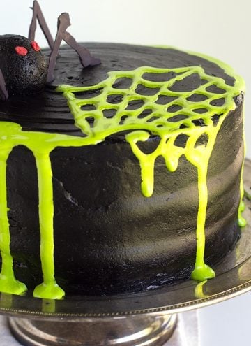 Spooky Spiderweb Cake - the perfect chocolate Halloween cake with black chocolate frosting and toxic green fluff sludge. It should be at all the parties!